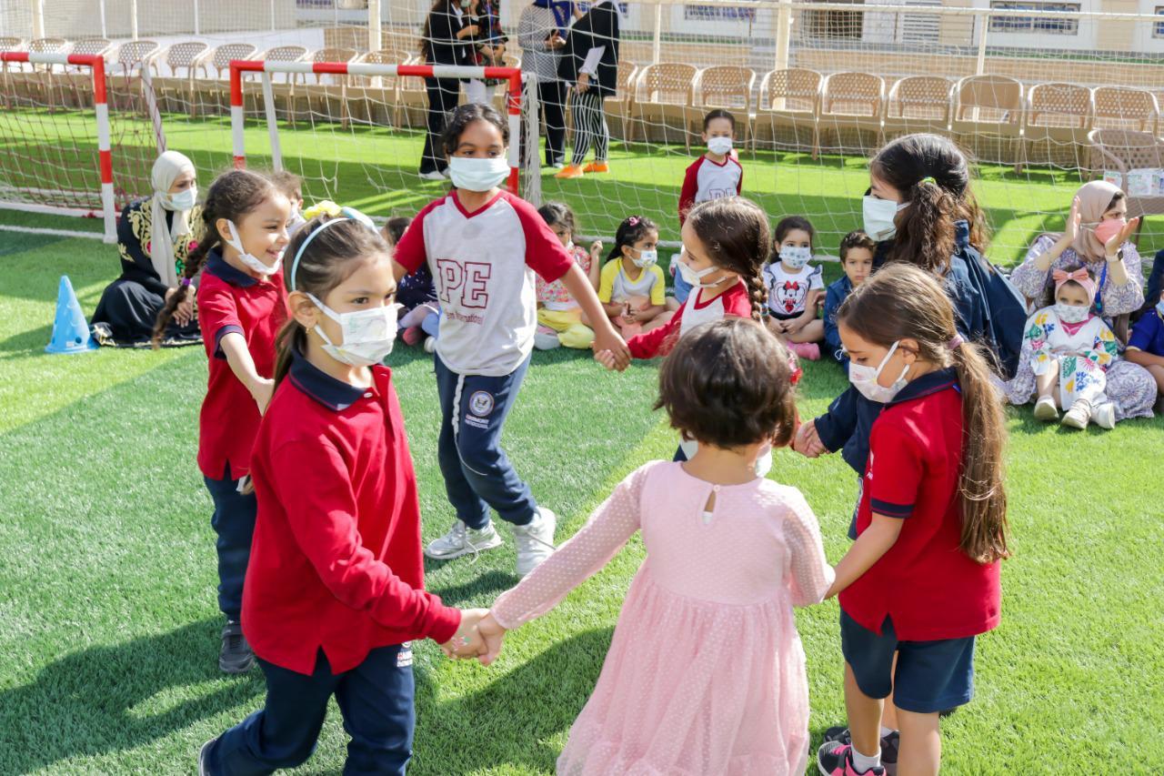 Children from IVY STEM International School participating in a collaborative sports activity while following COVID-19 safety measures.
